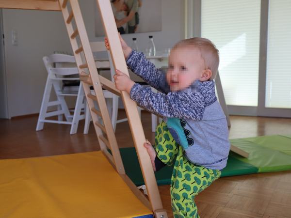 Meine Tochter klettert an einer Stange nach oben.